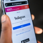 Ekranında Instagram logosu görünen akıllı telefonu tutan el