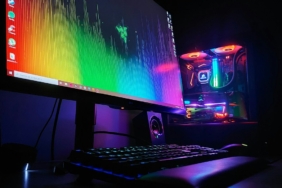 Oyun kasası ve açık monitörden oluşan masaüstü bilgisayar düzeni
